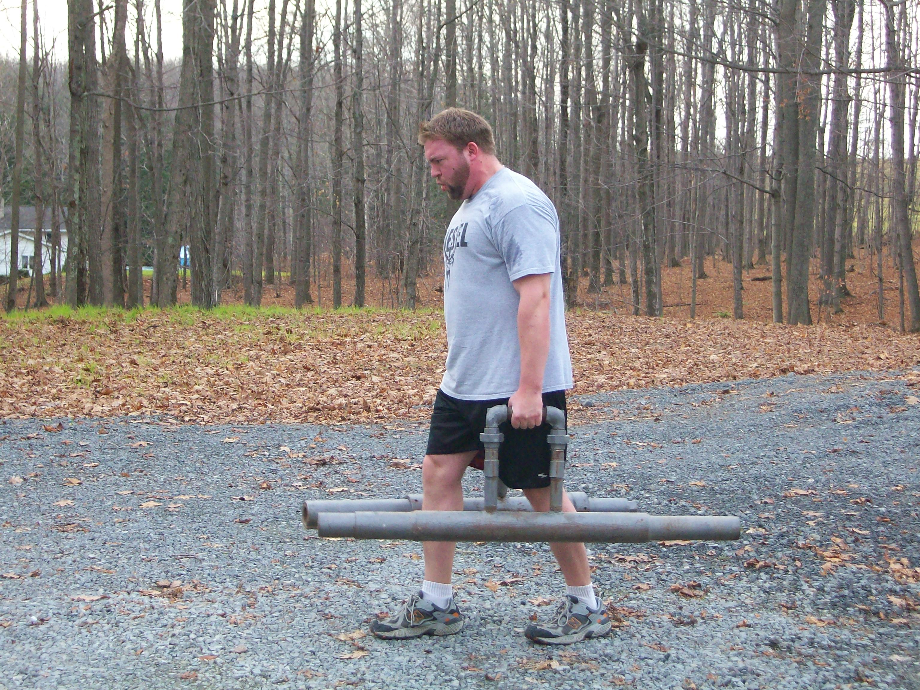 Man doing object lifting in woods.