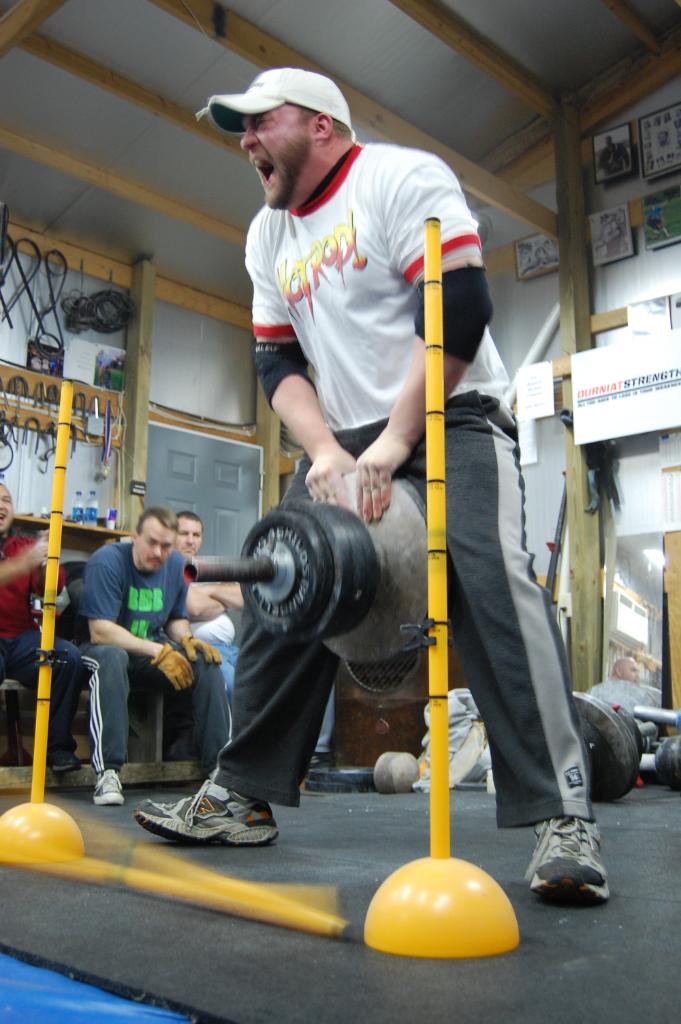 A man with lifting heavy dumbbell.